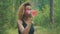 Black woman drinking from pink bottle. Portrait of black young woman taking break while jogging