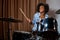 Black woman drummer in a recording studio