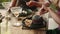 Black woman eating hamburger and french fries in restaurant. Tanned female having black burger and with potato wedges