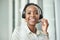 Black woman face, call center and phone consultation with a smile in a office with contact us work. Telemarketing