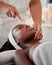 Black woman, face roller and luxury spa treatment of a young female ready for facial. Skincare, rose quartz tool and