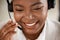 Black woman, face and smile with headphones in call center for customer service, support or telemarketing. Happy African