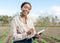 Black woman, farmer and with clipboard for harvest, vegetables and check plants growth outdoor. Portrait, agriculture