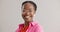 Black woman, glasses and portrait with smile in studio with fashion for vision, sight or eye care on grey background