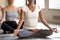 Black woman and group of people practicing yoga, Ardha Padmasana