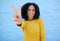 Black woman, hand and peace sign for victory, win or letter V against a blue wall background on mockup. Hand of happy