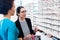 Black woman inspecting glasses in optician shelf