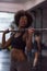 Black woman lifting empty bar