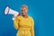 Black woman, megaphone and portrait, protest and voice, freedom of speech and activism on blue background. Female smile