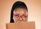 Black woman, notebook and hide face in studio for thinking, glasses or planning schedule for small business online