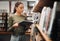 Black woman reading book in a library for education, studying and research in school, university or college campus