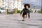 Black woman on roller skates falling to the ground.