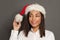 Black woman Santa smiling on gray background