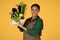 Black Woman Showing Harvest Holding Box With Vegetables, Studio Shot