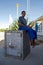 Black woman sitting on a bank safer at the Namibian border in Bo