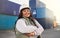 Black woman, smile and work in logistics with container stack at shipyard. Woman, happy and confident has motivation