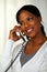 Black woman smiling and speaking on phone