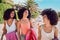 Black woman, sun and friends on beach in summer for outdoor break, holiday and happiness. Travel, smile and vacation