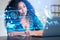 Black woman take note and looking at laptop, face recognition hologram