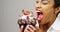 Black woman taking a huge bite out of a fancy dessert