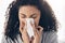 Black woman, tissue and sneeze of a sick young person blowing nose with toilet paper for safety. Flu, fever and cold of