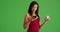 Black woman using smartphone diet app to check food nutrition on green screen