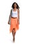 Black woman walking wearing orange skirt