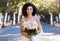 Black woman, wedding and bride portrait with bouquet of roses happy about love celebration. Street, happiness and