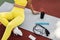 Black woman in yellow sportswear sitting on mat with equipment