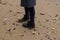 Black womans leather boots on the sand