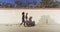 Black women friends walking across beach wall with chairs in hand