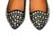 Black women\'s leather ballet flats with steel rivets close up