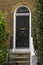 Black Wooden Entrance Door to residential building in London. Typical door in the English style