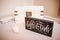 Black wooden Gifts and Cards sign near a white wooden box on a white table