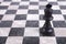 Black wooden king on chessboard