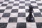 Black wooden queen on chessboard