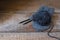 Black wool yarn on the handmade mitt, rustic wabi sabi style background