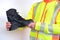 black work boots made of leather with reinforced cape, high top in hands of man, mature male mature builder, worker in yellow work