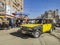 A black and yellow antiquated Lada taxi driving through the beaten road in Alexandria