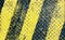 Black and yellow line paint on non-slip metal texture background