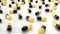 Black and yellow pills rotate on white table.