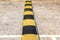 Black and yellow striped road bumps installed in front of a pedestrian crossing to reduce vehicle speed