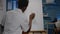 Black young artist retouching vase design on canvas and easel