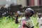 Black young beautiful girl having fun outdoors blowing soap bubbles. Happiness symbol. Elementary student happy outside her