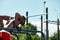 Black young man exercising on the uneven bars in the park, crossfit concept, african american man doing exercises on the