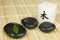 Black zen pebbles, green leaf and japanese candle