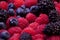 Blackberries, blueberries and raspberries, table top view
