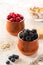 Blackberries and raspberries in ceramic pots