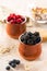 Blackberries and raspberries in ceramic pots