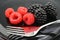Blackberries, raspberries and a fork